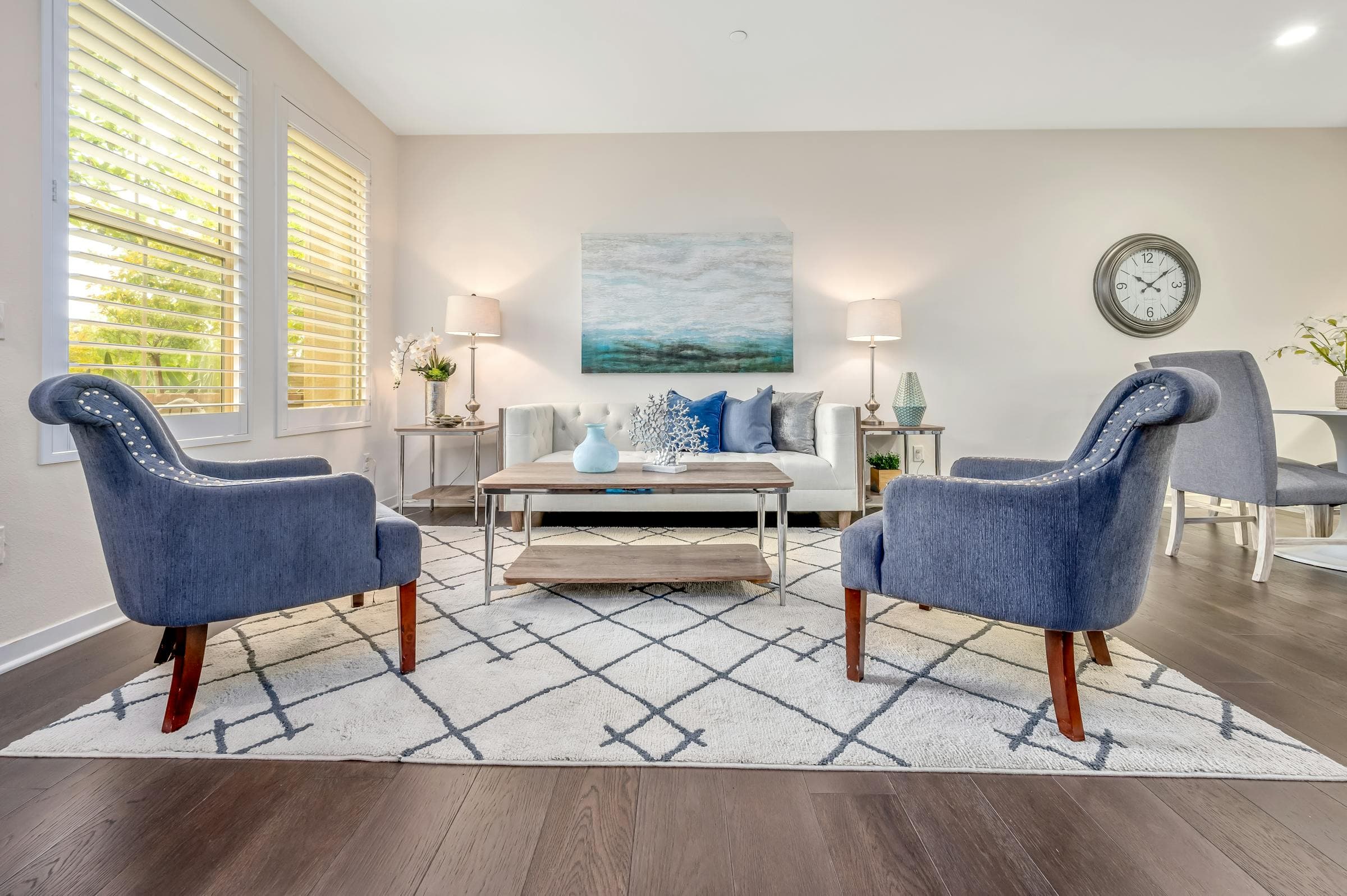 Bright coastal living room with blue accents, representing a comfortable family home