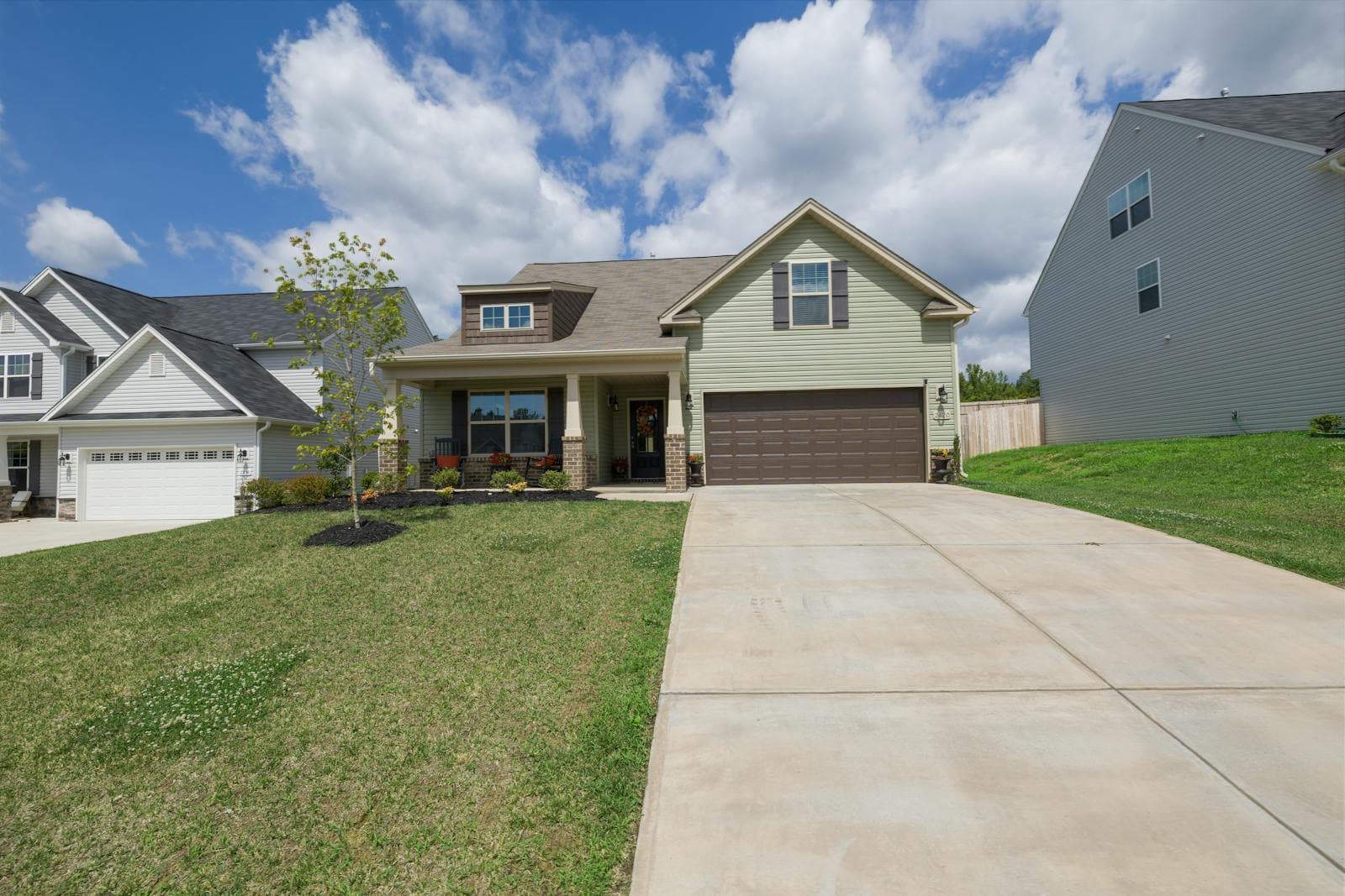 Modern two-story suburban home with a driveway and landscaped yard