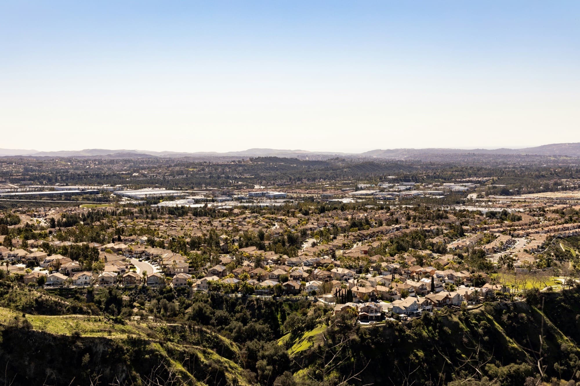 Lake Forest neighborhoods spread across the valley, seen from the green foothills above