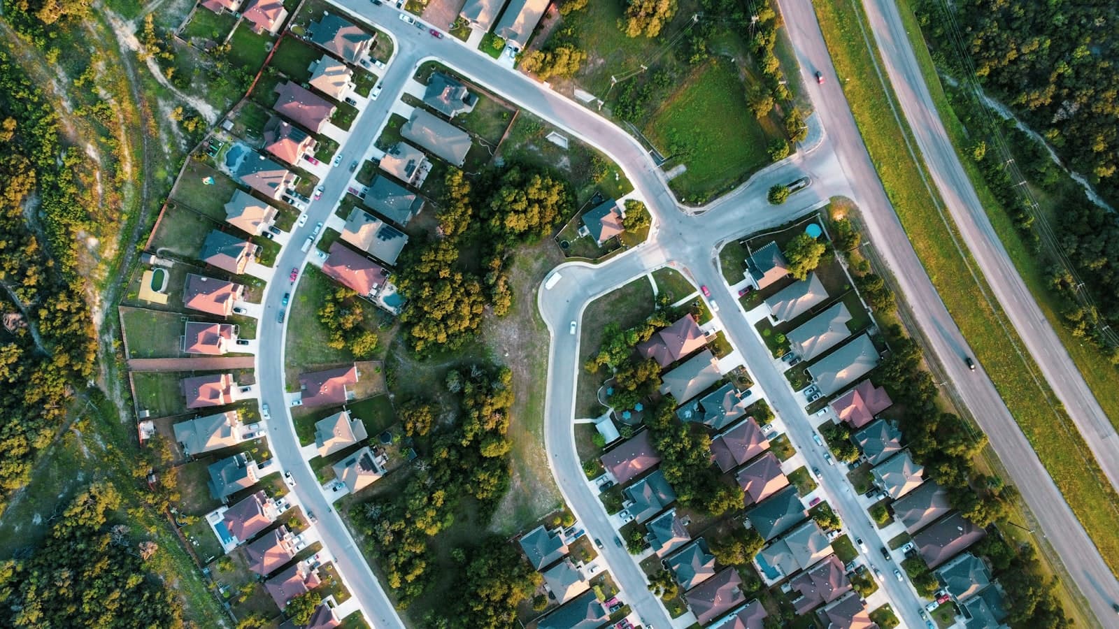 Aerial view of a master-planned suburban neighborhood with curved streets and rows of homes