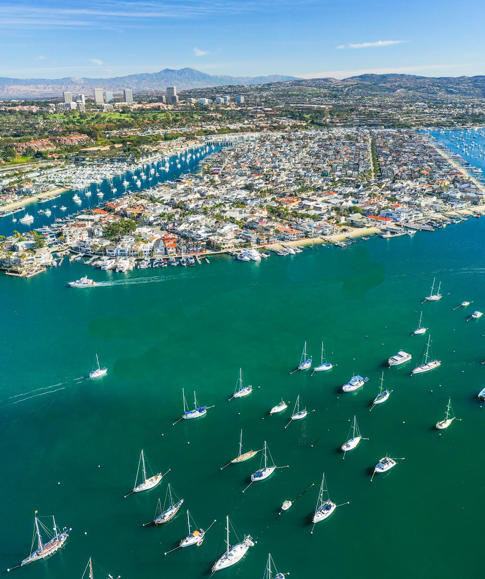 Aerial view of Newport Harbor at dusk with sailboats and marina