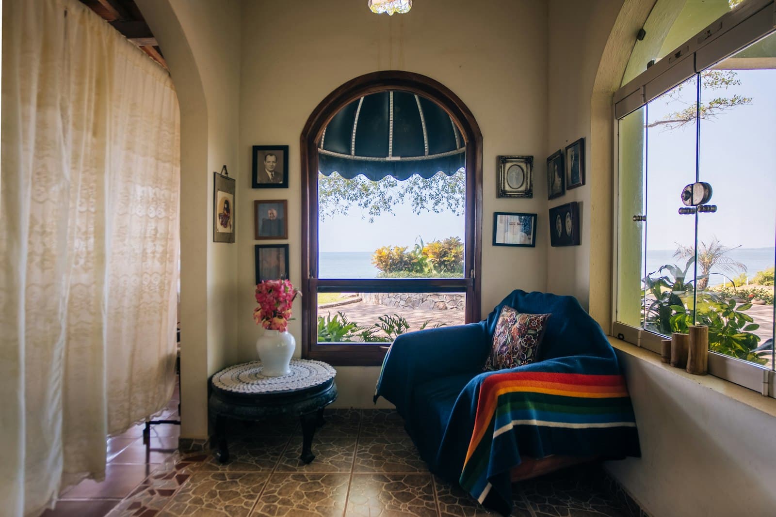 Bright coastal living space with an arched window overlooking the Pacific